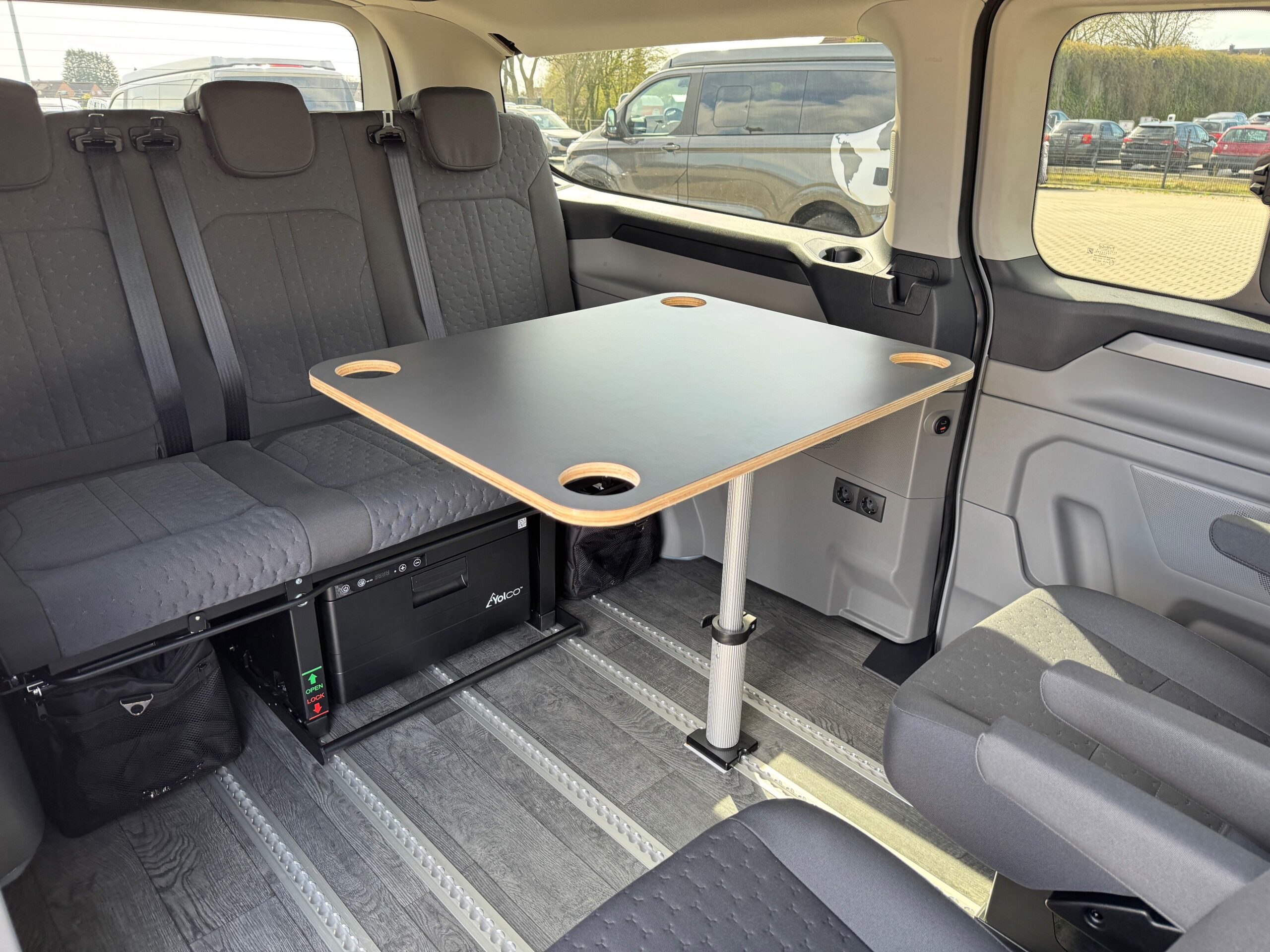 Camping table for an airline rail in the interior